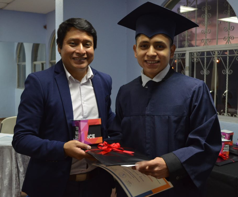 team-member-spotlight-lucas-pinzon-3 Lucas Pinzon presenting graduate with gift and certificate