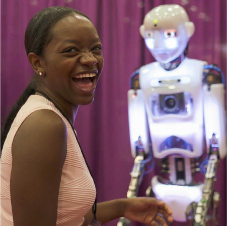 Scholar girl learning about robotics at conference Scholar girl learning about robotics at conference