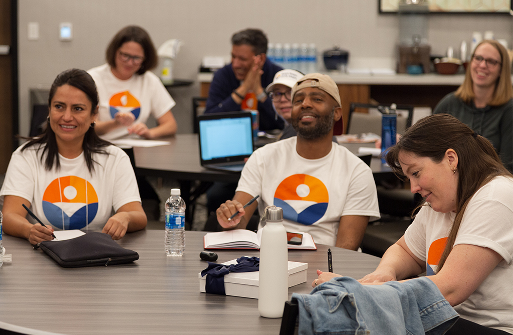 Team members in meeting laughing