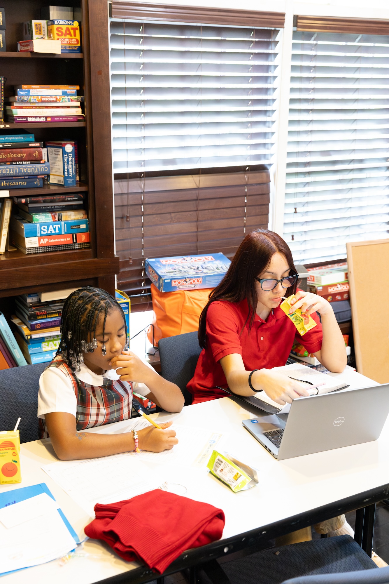 scholar girls of varying ages studying together in the residential house